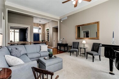 Large carpeted living room with crown molding