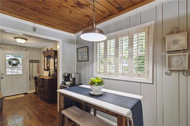 Dining space with wooden ceiling and dark wood finished floors
