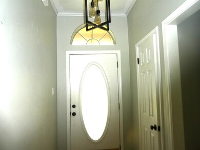 Entrance foyer featuring ornamental molding