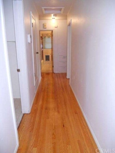 Recently refinished hardwood floors in hallway lea