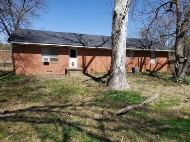 Back of house with brick siding, crawl space, cent
