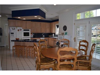 Kitchen. Open area with bar and eat in kitchen are
