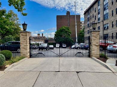 Gated parking beside building.