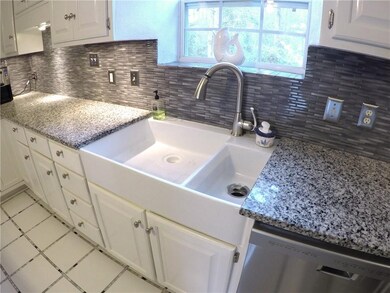 New granite countertops and farmhouse sink.