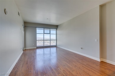 Unfurnished room with wood finished floors and bas