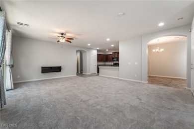 Large family room with arched walkways, ceiling fa