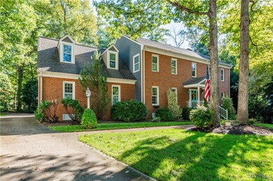 Colonial house featuring a front lawn