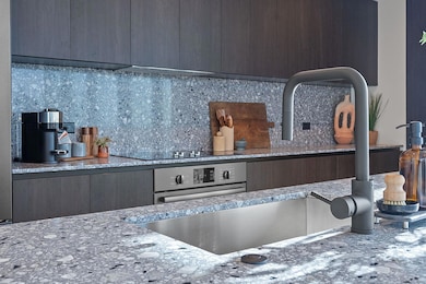 Kitchen with tasteful backsplash, stainless steel