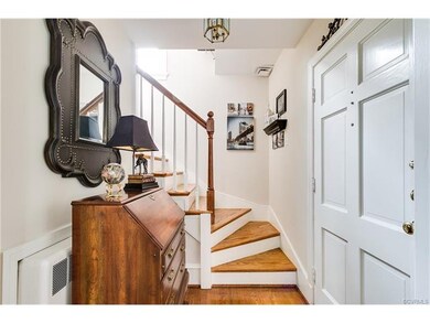 The entrance opens to the living room and beautiful staircase.