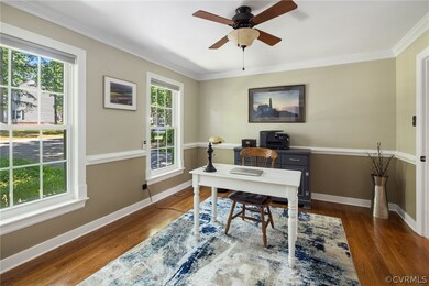 Home office with ceiling fan, a healthy amount of