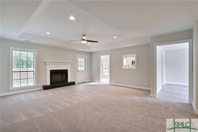 Great Room with fireplace, recessed lighting, trey