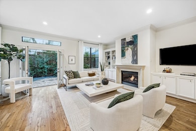 [Family Room] French doors and windows along the back of the room beautifully blend the indoors with the private patio. It seamlessly floods the space with natural light and expands your living area.