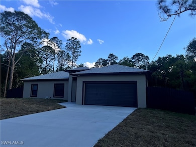 Ranch-style house with a garage, concrete driveway