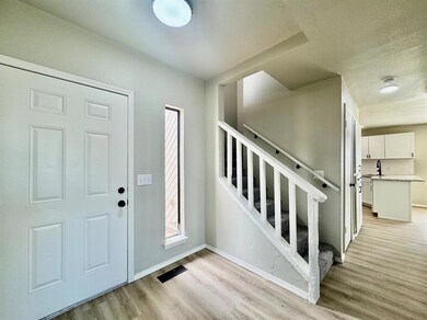 Entryway featuring light wood-style floors, basebo