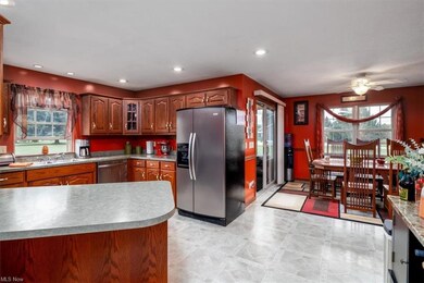 Kitchen with ceiling fan, light countertops, stain