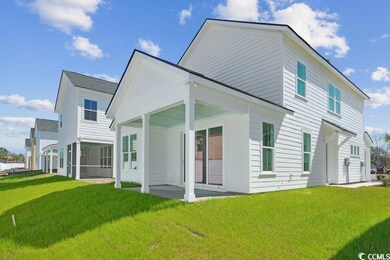 Back of house featuring a patio and a yard