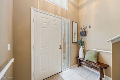 Tiled entrance foyer with baseboards