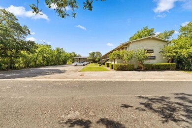 View of front of house with brick siding and uncovered parking