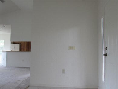 From front doors looking in toward kitchen in the 