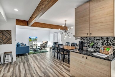 Kitchen with beam ceiling, light wood-type floori