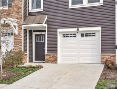 View of exterior entry with a garage