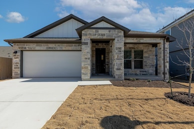 View of front of property with driveway, a garage