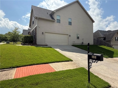 View of home's exterior with driveway, an attached garage, and a shingled roof