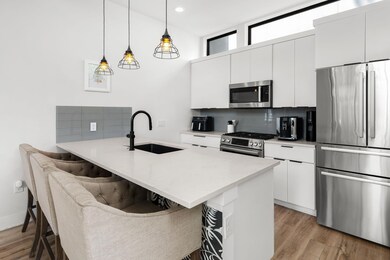 Kitchen with decorative backsplash, a kitchen bre