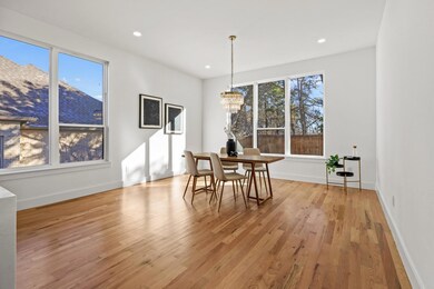 Dining space featuring a chandelier, light wood-ty