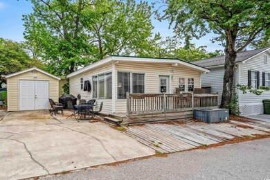 Back of house with a wooden deck, a patio area, an
