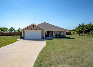 Single story home featuring a garage and a front l
