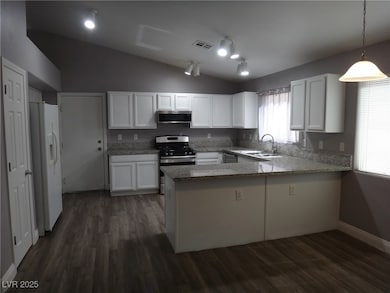 Kitchen featuring a peninsula, white refrigerator