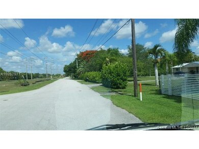 lot entrance road between pink house and white fen