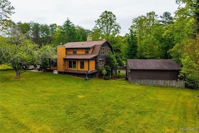 Back of house with a chimney, a gambrel roof, and
