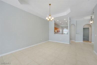 Unfurnished living room with a chandelier, arched