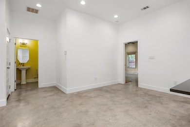 Spare room featuring baseboards, visible vents, a