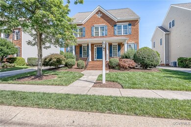 View of front of home featuring brick siding, a porch, a front lawn, and roof with shingles