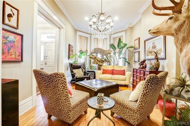 Large Living Room has bay window and beautiful cha
