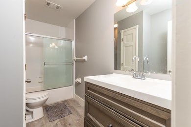 Full bathroom featuring vanity, hardwood / wood-st