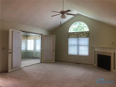 living room leads to sunken sun room w/new windows