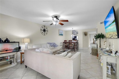 Living area with light tile patterned flooring and a ceiling fan