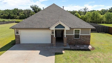 View of front facade with brick siding, concrete driveway, an attached garage, and a shingled roof