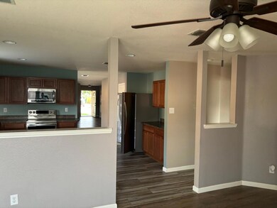 Kitchen with dark hardwood / wood-style floors, ce