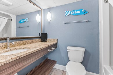 Bathroom with tile patterned flooring, toilet, van