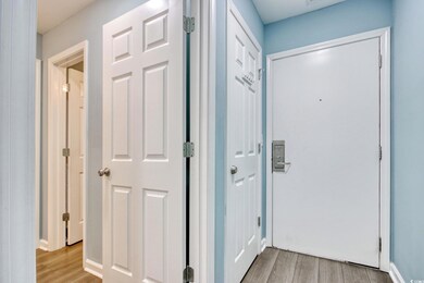 Hallway featuring light wood finished floors