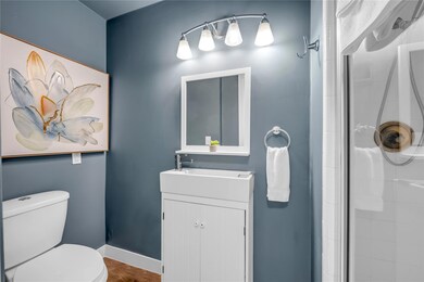 Full bathroom featuring a shower stall and vanity