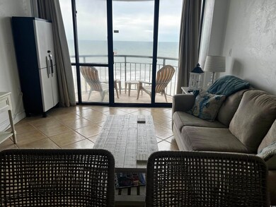 Tiled living room with direct views of ocean and b