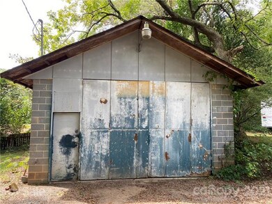 The adjacent .13 acre lot with large brick garage 