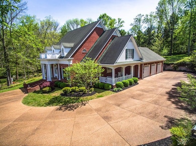 Aggregate drive and 3 car garage with additional space for a shop.