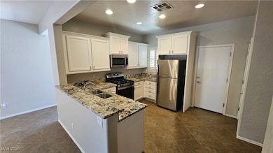 Kitchen featuring a sink, stainless steel applianc
